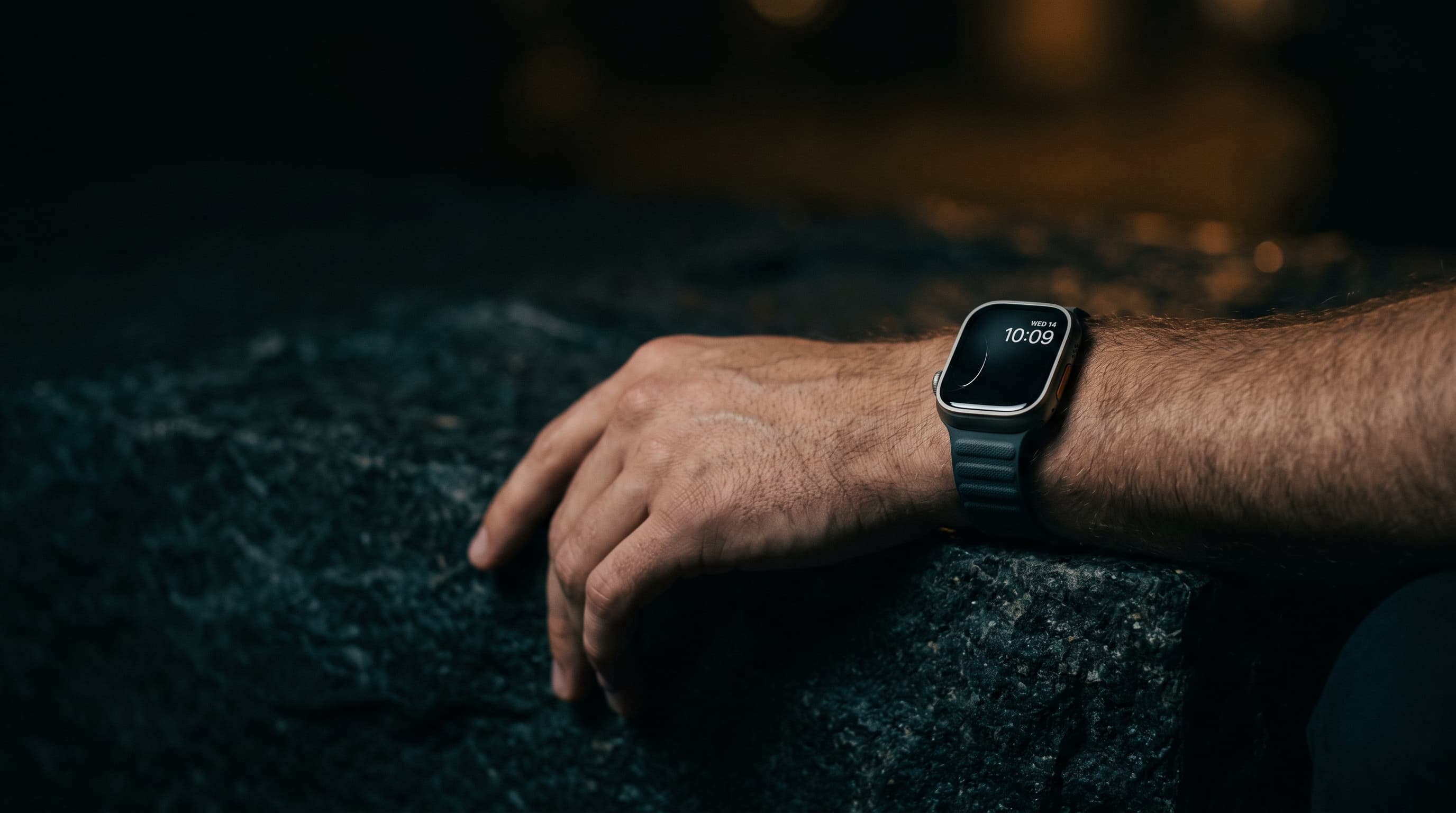 Epoch One on a wrist resting on dark stone at night, its display glowing softly